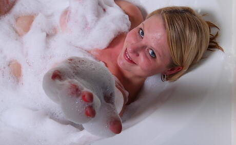 Peachy mature Lynn Miller baring big tits and hairy pussy in bathroom